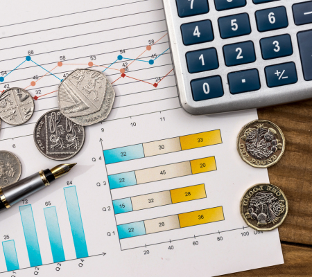 Calculator and chart with pound coins